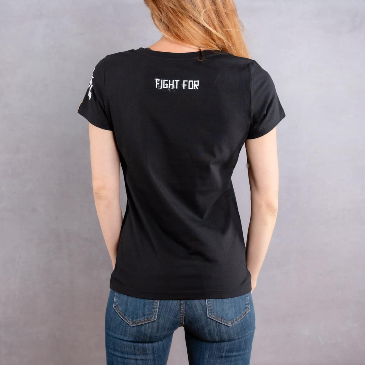 Image de dos d'une femme portant un T-Shirt noir slim au logo blanc de la collection Cabal Skull