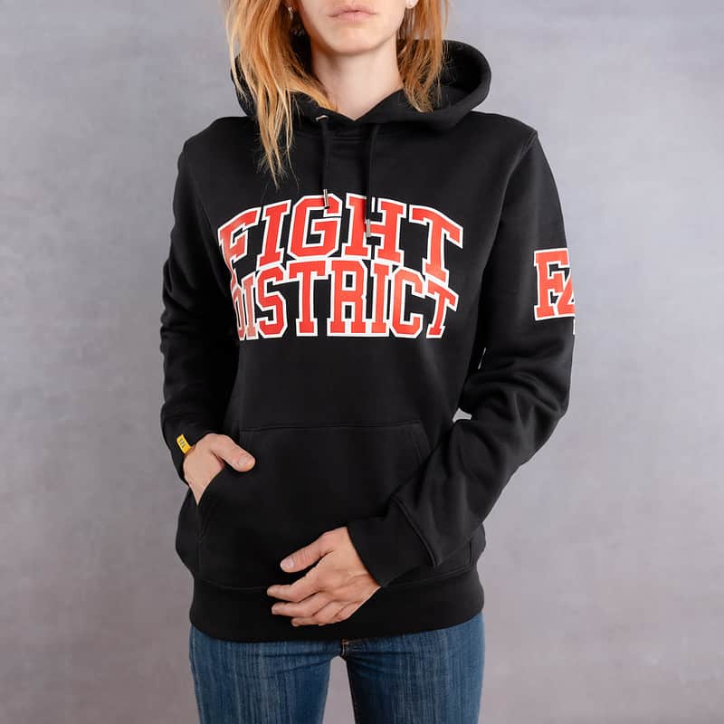 Image de face d'une femme portant un hoodie noir au logo rouge de la collection College