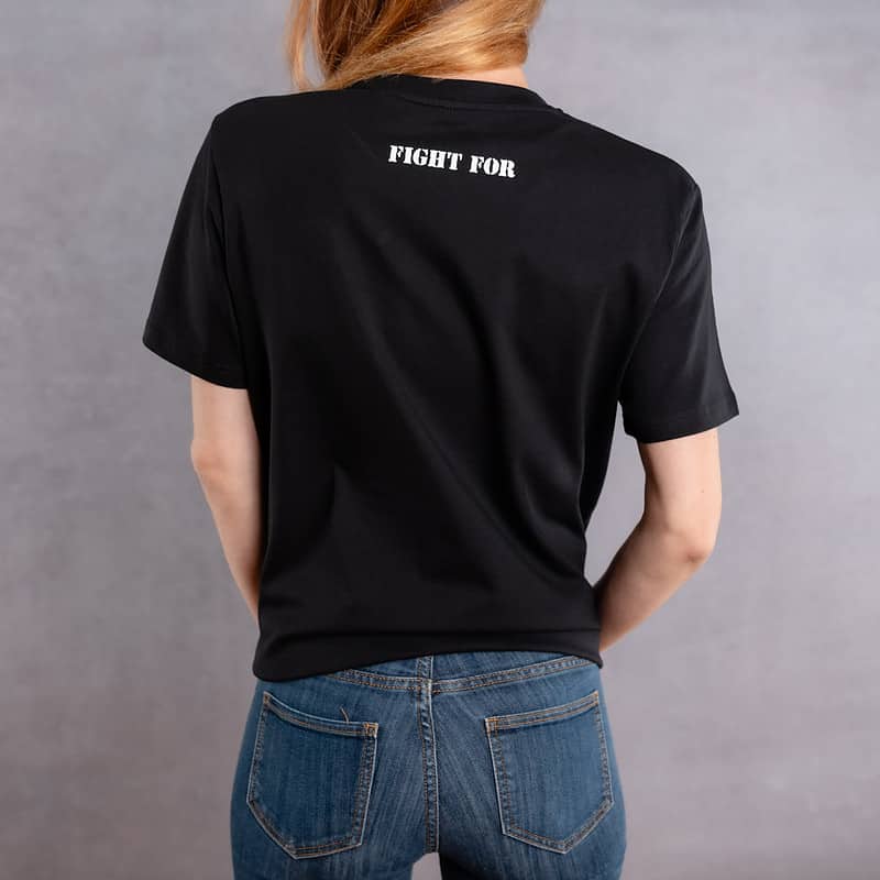 Back photo of a woman wearing a black T-shirt with a white logo from The Original collection.
